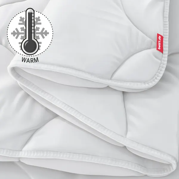 Die zusammengefaltete BODYGUARD Winterdecke warm. Illustration eines Thermometers, das eine hohe Temperatur zeigt. Text: warm